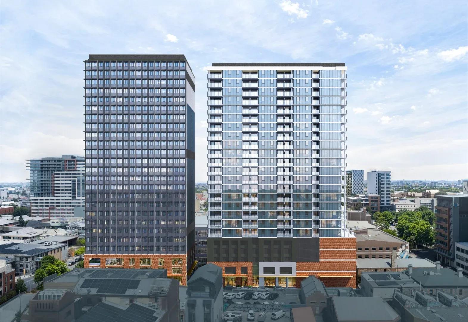 繁華都市街區中兩座現代高層住宅大樓的空中渲染圖，採用玻璃外牆與磚砌基座設計，矗立於晴朗的藍天之下。